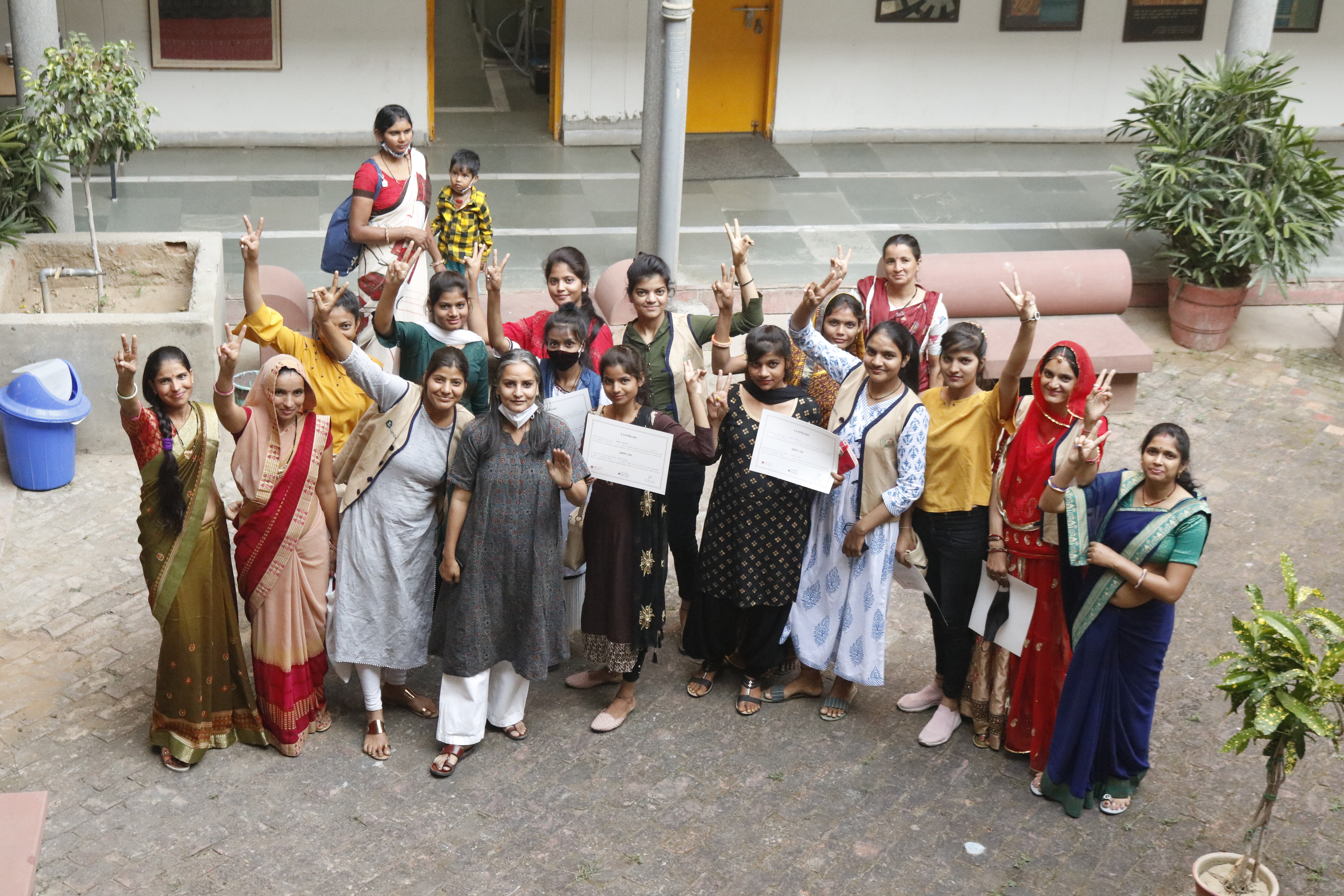 Artisans stitching fabric products at Sikra workshop